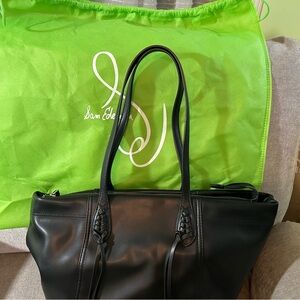 Frame tote bag with fabric storage bag. Braided front accents.